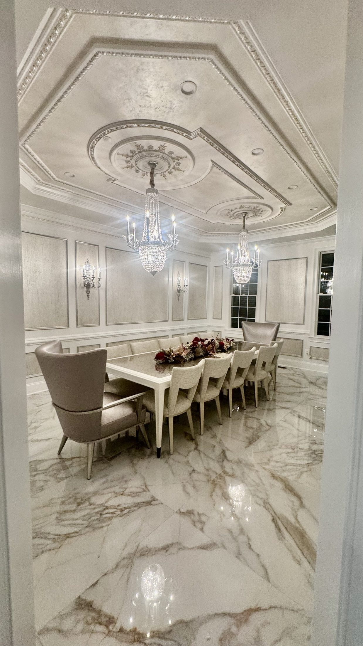 Formal Dining: paneled walls, twin crystal chandeliers, seating for twelve, designed and furnished by John Hashempour
