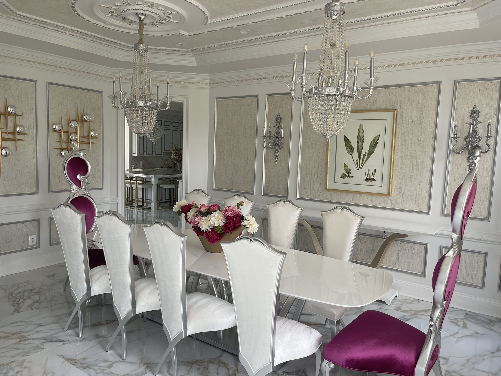 Dining room with velvet host chairs and crystal chandeliers, designed by John Hashempour